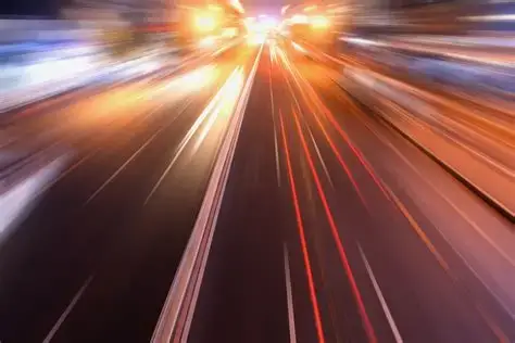 Dynamic motion blur of light streaks on a road, representing high-speed data flow and signal integrity in advanced PCB manufacturing.